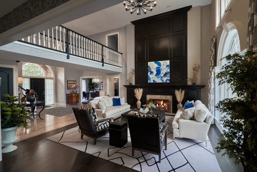 Living room with open staircase, fireplace, and contemporary decor