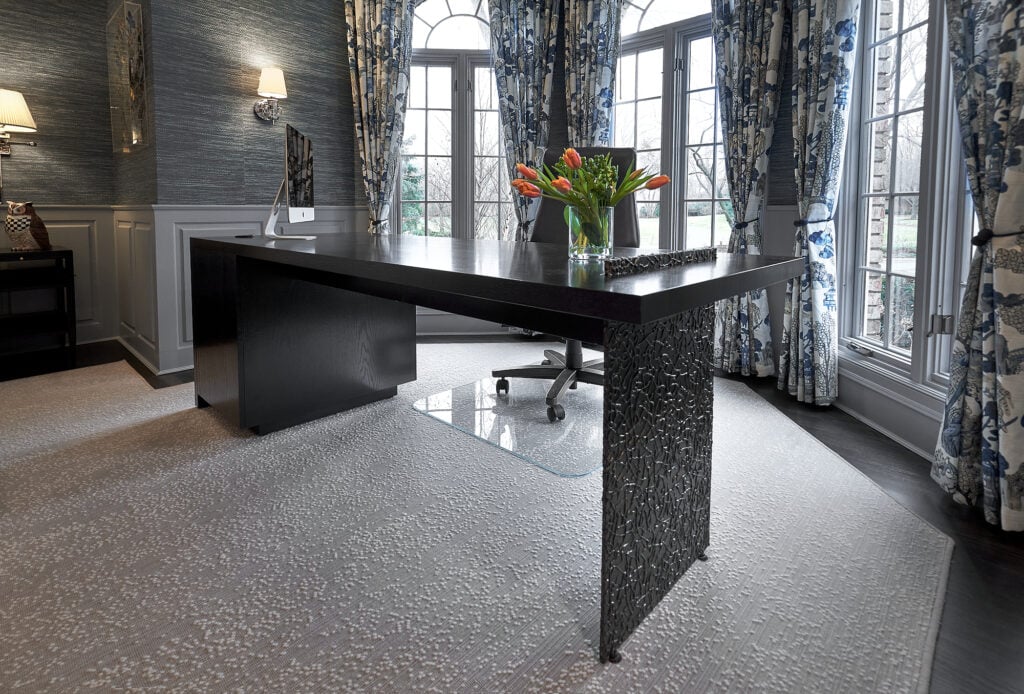 Dark wood desk in gray room, with patterned curtains