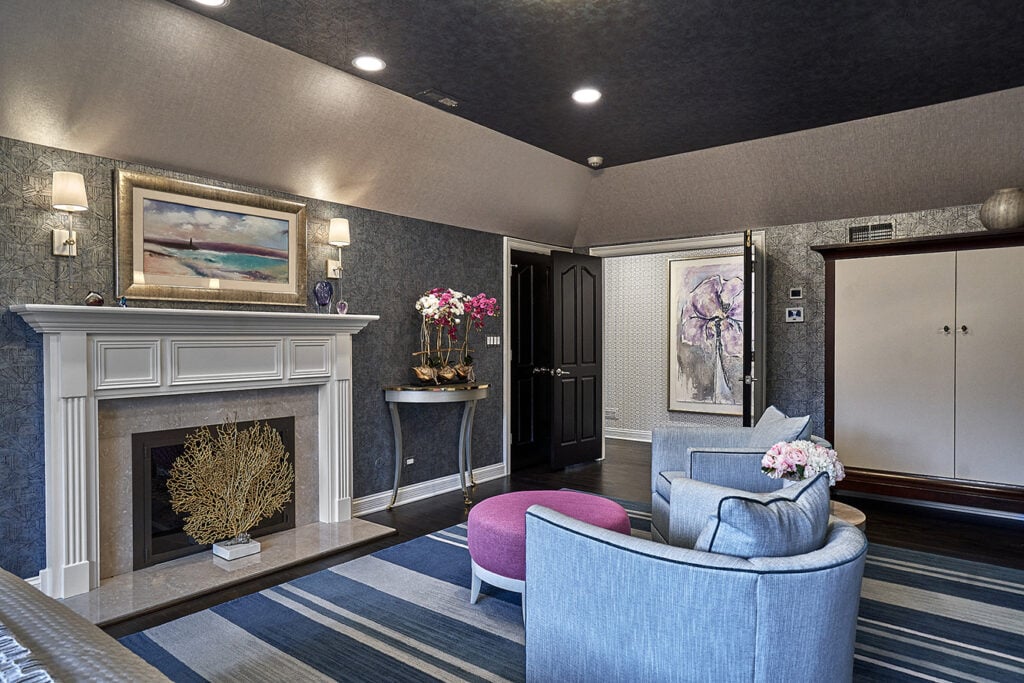 Living room fireplace artwork armchairs striped rug