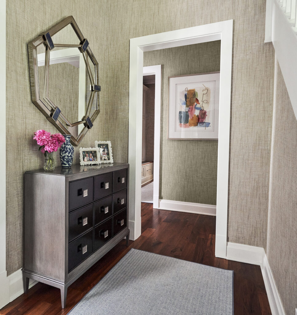 Hallway chest mirror framed art doorway rug
